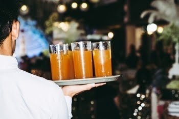 Picture of a server carrying a tray of drinks